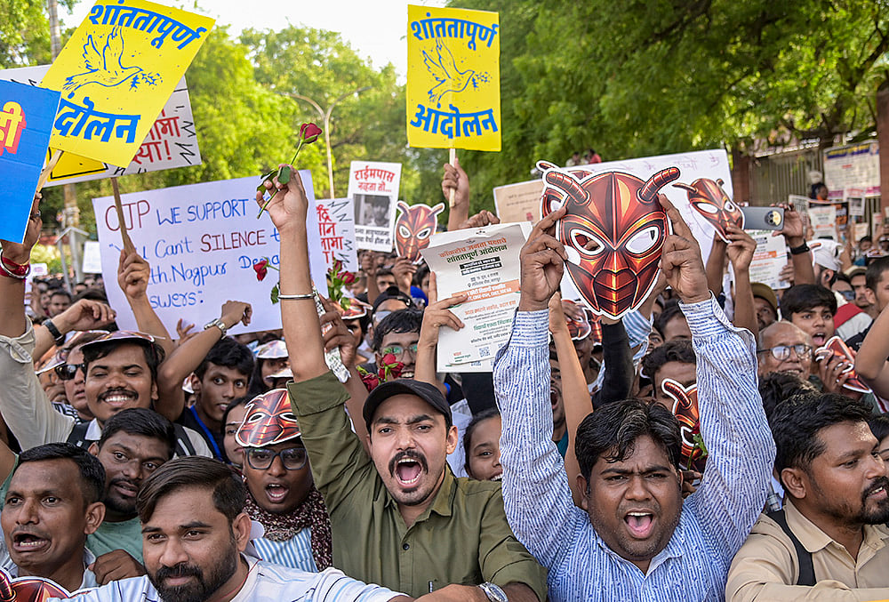 Cockroach Janta Party (CJP) supporters stage a protest demanding the resignation of Union Education Minister Dharmendra Pradhan over last month's NEET (UG) paper leak issue, in Nagpur. - | Photo: PTI