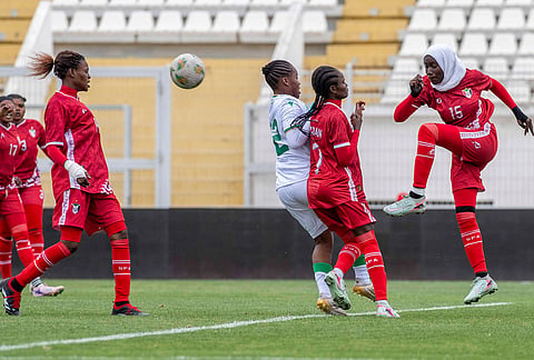 Sudan's U-17 women's national team players, in red, defend the ball during a soccer match against Comoros, during qualifiers for the 2028 Los Angeles Summer Olympics, in Casablanca, Morocco.