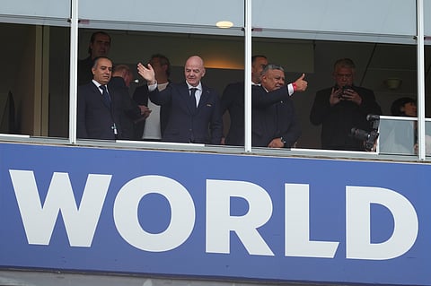 FIFA President Gianni Infantino, center, waves from the tribune during the World Cup Group J soccer match between Argentina and Algeria in Kansas City, Mo., Tuesday, June 16, 2026.
