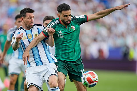 Argentina's Lionel Messi and Algeria's Rayan Ait-Nouri battle for the ball during the World Cup Group J soccer match between Argentina and Algeria in Kansas City, Mo., Tuesday, June 16, 2026.