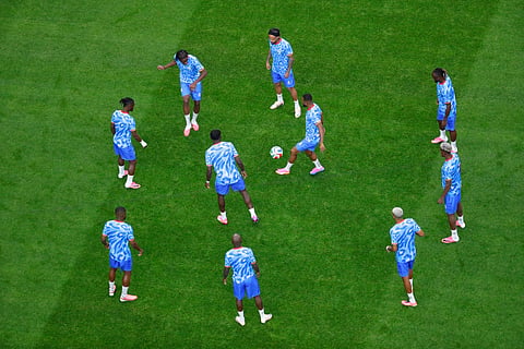 Members of team Congo warm up during the World Cup Group K soccer match between Portugal and Congo in Houston, Wednesday