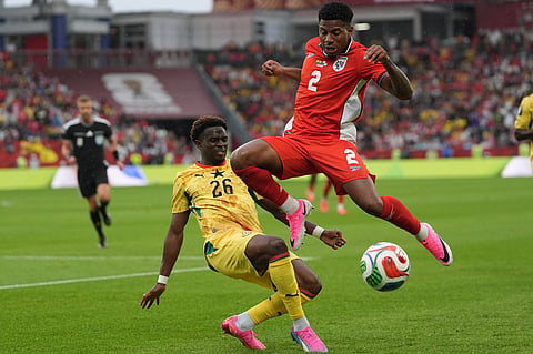 Panama's Cesar Blackman, right, jumps over Ghana's Marvin Senaya during the World Cup Group L soccer match between Ghana and Panama in Toronto