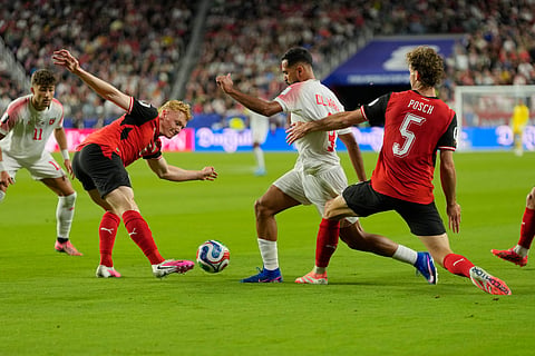 Jordan's Ali Olwan (9) battles for the ball with Austria's Nicolas Seiwald (6), left, and Austria's Stefan Posch (5) during the World Cup Group J soccer match between Austria and Jordan in Santa Clara, Calif., near San Francisco, Tuesday, June 16, 2026.