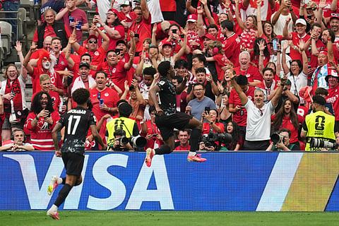 Canada's Jonathan David, right, celebrates after scoring his side's second goal during the World Cup Group B soccer match between against Qatar in Vancouver, British Columbia, Thursday, June 18, 2026.