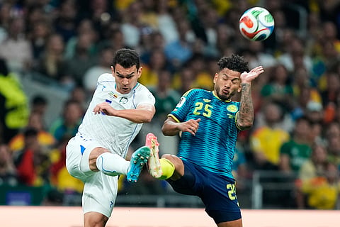 Uzbekistan's Rustam Ashurmatov and Colombia's Luis Suarez, right, battle for the ball during the World Cup Group K soccer match between Uzbekistan and Colombia in Mexico City, Wednesday, June 17, 2026