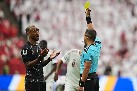 Canada's Derek Cornelius, left, reacts as he receives a yellow card during the World Cup Group B soccer match against Qatar in Vancouver, British Columbia, Thursday, June 18, 2026.
