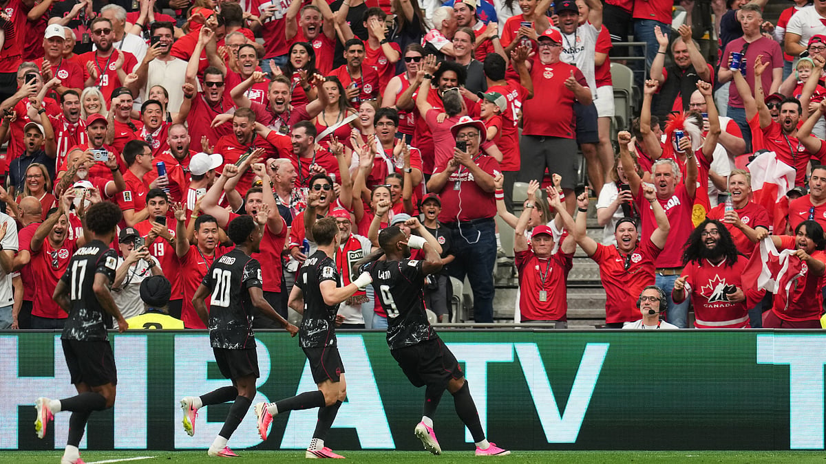 Canada's Cyle Larin, right, celebrates after scoring his side's opening goal during the World Cup Group B soccer match against Qatar in Vancouver, British Columbia, Thursday, June 18, 2026. - (AP Photo/Abbie Parr)