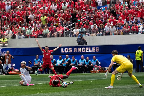Switzerland's Breel Embolo (7) center, is fouled by Bosnia's Tarik Muharemovic (4), left, during the World Cup Group B soccer match between Switzerland and Bosnia in Inglewood, Calif, near Los Angeles, Thursday, June 18, 2026.