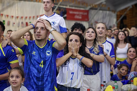 Bosnian soccer fans react as they watch a broadcast of the World Cup Group B soccer match between Switzerland and Bosnia at a fan zone in Sarajevo, Bosnia, Thursday, June 18, 2026.