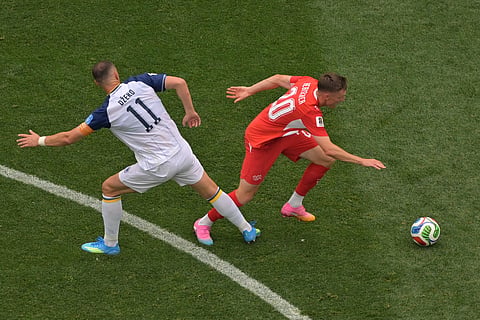 Switzerland's Michel Aebischer (20) passes Bosnia's Edin Dzeko (11) during the World Cup Group B soccer match between Switzerland and Bosnia in Inglewood, Calif., near Los Angeles, Thursday, June 18, 2026.