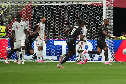 Canada's Cyle Larin, right, celebrates after scoring his side's opening goal during the World Cup Group B soccer match against Qatar in Vancouver, British Columbia, Thursday, June 18, 2026.