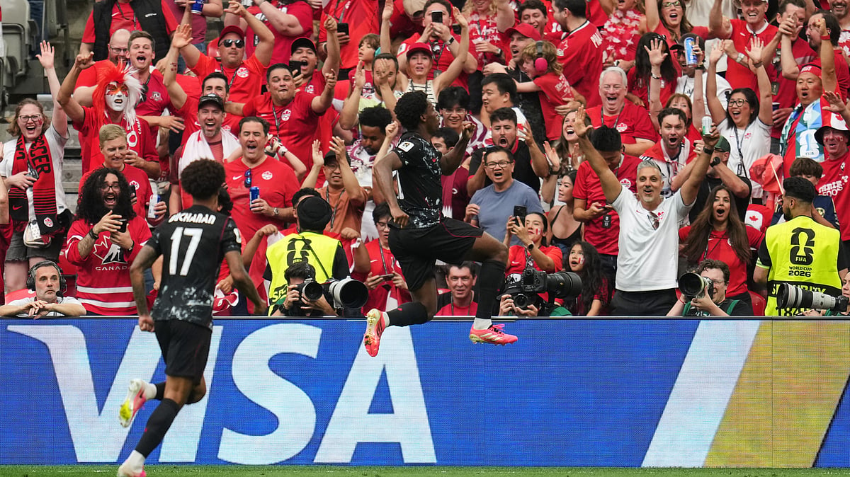 Canada's Jonathan David, right, celebrates after scoring his side's second goal during the World Cup Group B soccer match between against Qatar in Vancouver, British Columbia, Thursday, June 18, 2026. - (AP Photo/Abbie Parr)
