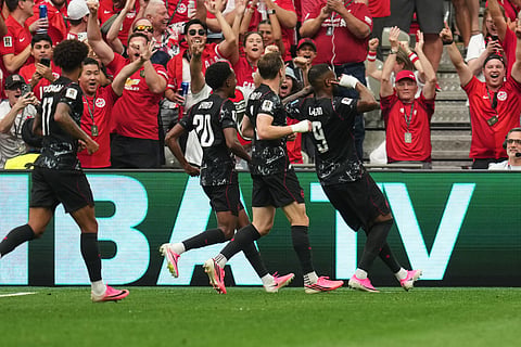 Canada's Cyle Larin, right, celebrates after scoring his side's opening goal during the World Cup Group B soccer match against Qatar in Vancouver, British Columbia, Thursday, June 18, 2026.