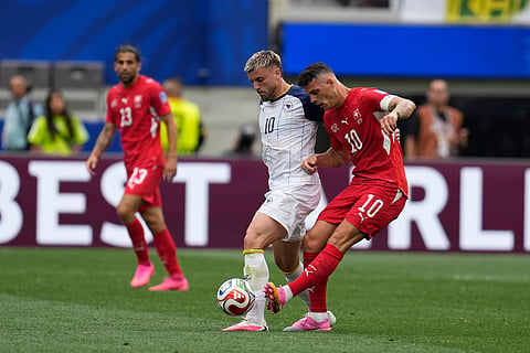 Bosnia's Ermedin Demirovic (10) challenges for the ball with Switzerland's Granit Xhaka (10), right, during the World Cup Group B soccer match between Switzerland and Bosnia in Inglewood, Calif, near Los Angeles, Thursday, June 18, 2026.