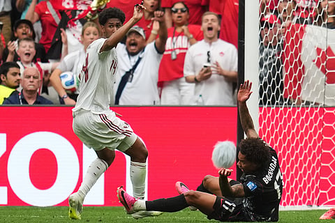 Canada's Tajon Buchanan, right, is fouled by Qatar's Homam Ahmed, resulting in a red card during the World Cup Group B soccer match in Vancouver, British Columbia, Thursday, June 18, 2026.
