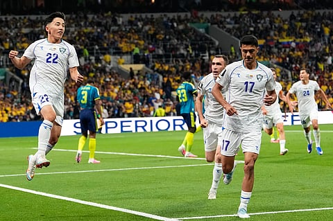 Uzbekistan's Abbosbek Fayzullaev, left, celebrates after scoring his team's first goal during the World Cup Group K soccer match between Uzbekistan and Colombia in Mexico City, Wednesday, June 17, 2026. 