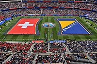 AP Photo/Jayne Kamin-Oncea : Swiss and Bosnian flags are seen on the pitch before the World Cup Group B soccer match between Switzerland and Bosnia in Inglewood, Calif., near Los Angeles, Thursday, June 18, 2026.
