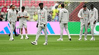 (AP Photo/Abbie Parr) : Qatar's Yusuf Abdurisag, center, walks on the pitch as his team arrives prior to the World Cup Group B soccer match against Canada in Vancouver, British Columbia, Thursday, June 18, 2026.