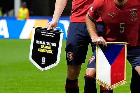 Czechia's team captain Ladislav Krejci holds a pennant reading "We Play Together. We Stand Against Hate" as the Czechia players pose before the World Cup Group A soccer match between Czechia and South Africa in Atlanta, Thursday, June 18, 2026.