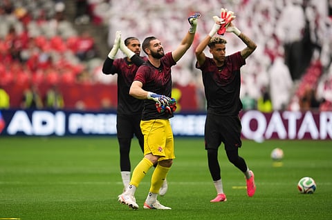 Canada goalkeeper Maxime Crepeau, center, waves to fans in the stands while warming up prior to the World Cup Group B soccer match against Qatar in Vancouver, British Columbia, Thursday, June 18, 2026.
