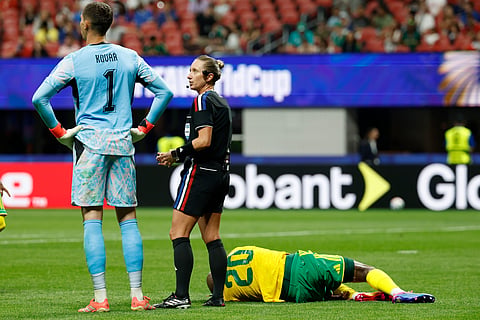 Referee Tori Penso, center, talks with Czechia goalkeeper Matej Kovar as South Africa's Khuliso Mudau lies on the ground during the World Cup Group A soccer match between Czechia and South Africa in Atlanta, Thursday, June 18, 2026.