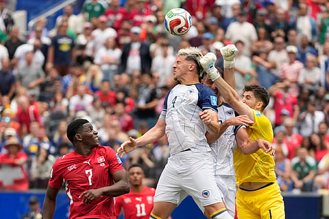 Bosnia goalkeeper Nikola Vasilj, right, clears the ball during the World Cup Group B soccer match between Switzerland and Bosnia in Inglewood, Calif., near Los Angeles, Thursday, June 18, 2026.