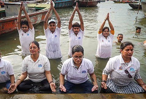 Members of Namami Gange perform 'jala yoga' in the Ganga ahead of the International Day of Yoga, in Varanasi.
