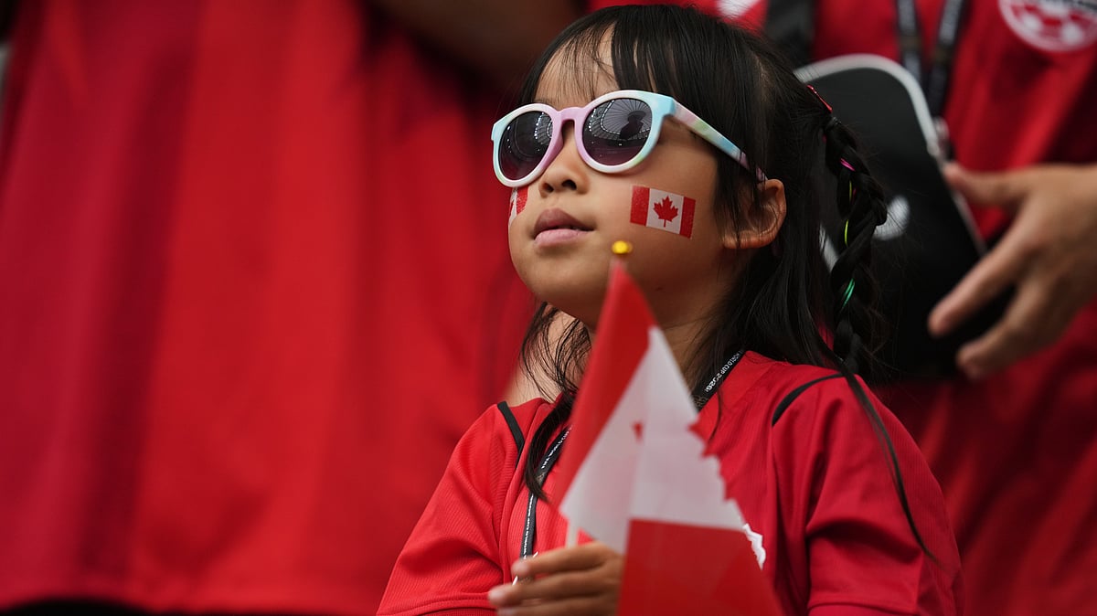 A young fan of Canada watches as teams arrive prior to the World Cup Group B soccer match between Canada and Qatar in Vancouver, British Columbia, Thursday, June 18, 2026. - (AP Photo/Abbie Parr)