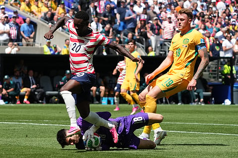 Australia goalkeeper Patrick Beach (18) saves in front of United States' Folarin Balogun (20) during the World Cup Group D soccer match between the United States and Australia in Seattle, Friday, June 19, 2026.