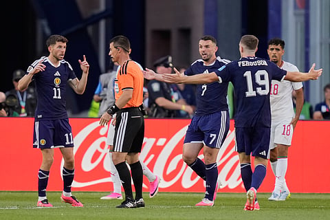 Scotland's Ryan Christie left appeals to referee Ilgiz Tantashev for a penalty, which was not given during the World Cup Group C soccer match between Scotland and Morocco in Foxborough, Mass., near Boston, Friday, June 19, 2026.