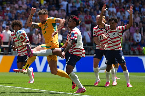 Australia's Cameron Burgess (21) battles for the ball with United States' Weston McKennie (8) during the World Cup Group D soccer match between the United States and Australia in Seattle, Friday, June 19, 2026.
