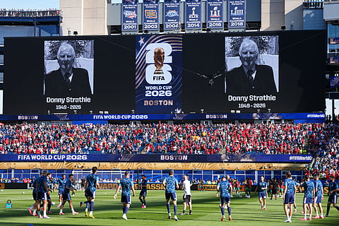 Portraits of late Scottish fan Donny Strathie are displayed on screen as the Scotland players warm up prior to the World Cup Group C soccer match between Scotland and Morocco in Foxborough, Mass., near Boston, Friday, June 19, 2026.