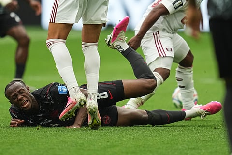 Canada's Ismael Kone falls while sustaining an injury during the World Cup Group B soccer match against Qatar in Vancouver, British Columbia, Thursday, June 18, 2026.