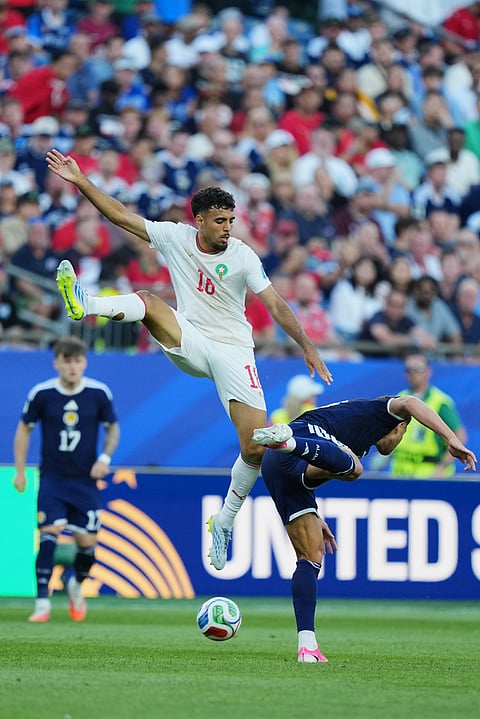 Morocco's Gessime Yassine, top, and Scotland's Che Adams compete for the ball during the World Cup Group C soccer match between Scotland and Morocco in Foxborough, Mass., near Boston, Friday, June 19, 2026.