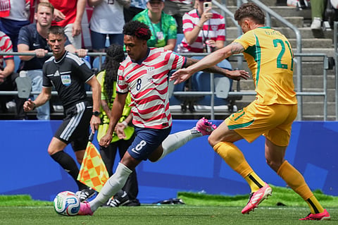 United States' Weston McKennie (8) sends a cross by Australia's Cameron Burgess (21) during the World Cup Group D soccer match between the United States and Australia in Seattle, Friday, June 19, 2026.