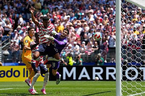 United States' Alex Freeman, center, scores his side's second goal past Australia goalkeeper Patrick Beach during the World Cup Group D soccer match between the United States and Australia in Seattle, Friday, June 19, 2026.