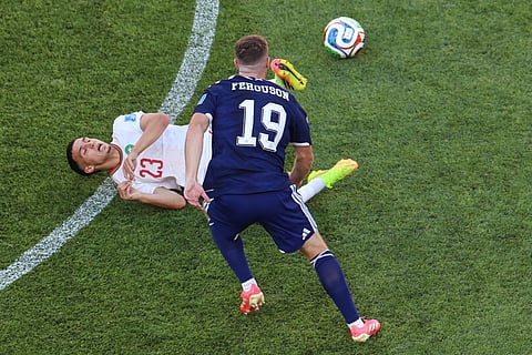 Scotland's Lewis Ferguson (19) and Morocco's Bilal El Khannouss (23) battle for the ball during the World Cup Group C soccer match between Scotland and Morocco in Foxborough, Mass., near Boston, Friday, June 19, 2026.