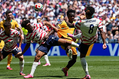 Australia's Nestory Irankunda fights for the ball with United States' Tyler Adams and Weston McKennie, right, during the World Cup Group D soccer match between the United States and Australia in Seattle, Friday, June 19, 2026.