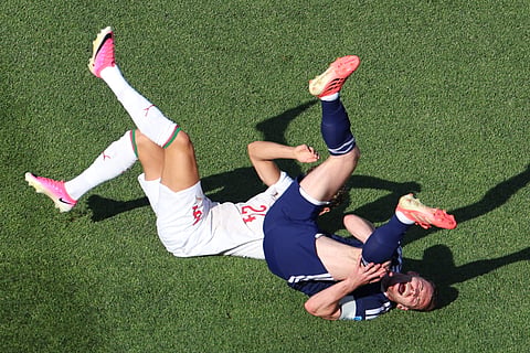 Scotland's Andy Robertson (3) and Morocco's Neil El Aynaoui (24) react after colliding during the World Cup Group C soccer match between Scotland and Morocco in Foxborough, Mass., near Boston, Friday, June 19, 2026.