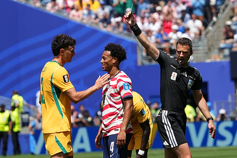 Australia's Alessandro Circati (3) receives a yellow card during the World Cup Group D soccer match between the United States and Australia in Seattle, Friday, June 19, 2026.