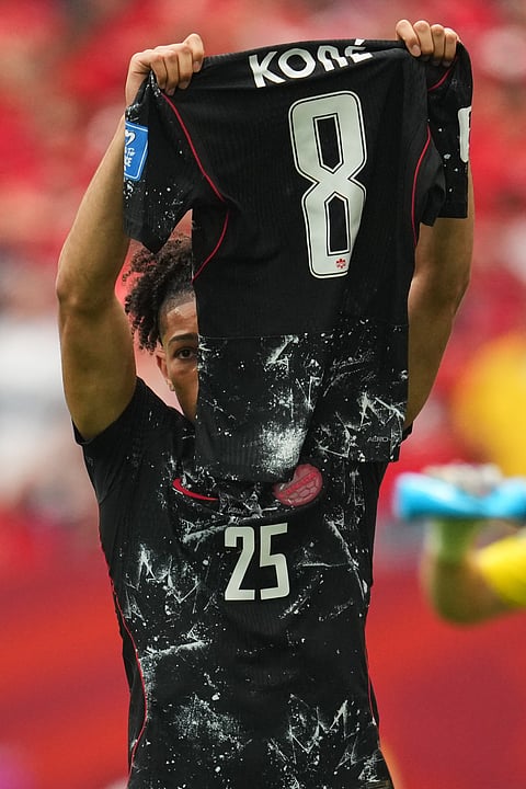 Canada's Nathan Saliba holds up the jersey of Ismael Kone after scoring his side's fourth goal during the World Cup Group B soccer match against Qatar in Vancouver, British Columbia, Thursday, June 18, 2026.