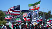 Outlook Explainer: Can A Team Win The World Cup If Politics Gets In The Way? AP Photo : People protest outside Los Angeles Stadium before the World Cup Group G soccer match between Iran and New Zealand in Inglewood, Calif., near Los Angeles.