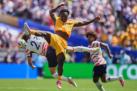Australia's Nestory Irankunda (17) and United States' Joe Scally (23) jump for the ball during the World Cup Group D soccer match between the United States and Australia in Seattle, Friday, June 19, 2026.