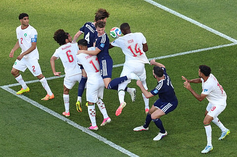 Players compete for the ball during the World Cup Group C soccer match between Scotland and Morocco in Foxborough, Mass., near Boston, Friday, June 19, 2026.