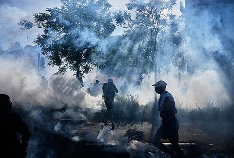 Protesters and others disperse amidst tear gas during a "No G7" demonstration in Geneva, Switzerland, ahead of the G7 summit scheduled to take place June 15-17. 