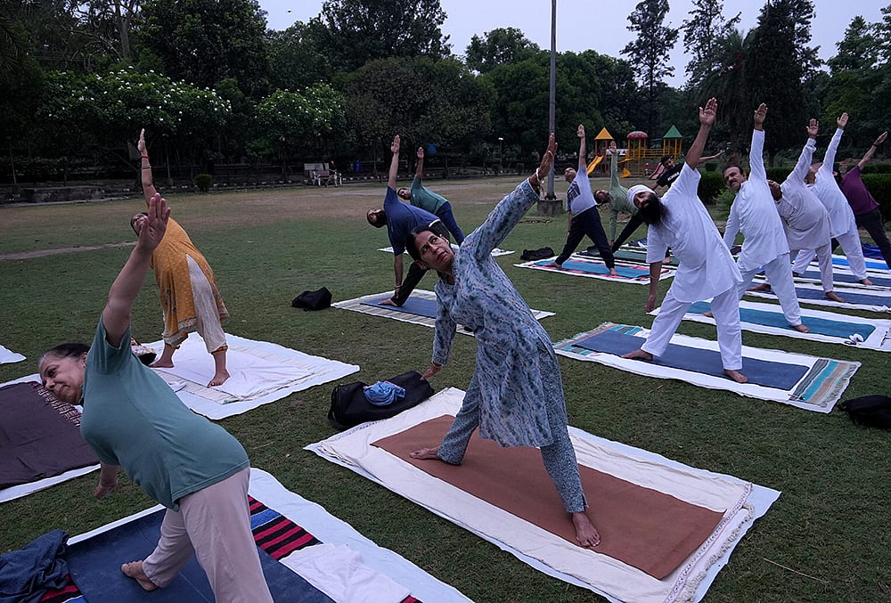 People take part in a yoga session at a garden ahead of the International Yoga Day, in Amritsar, Punjab. - | Photo: PTI/Shiva Sharma
