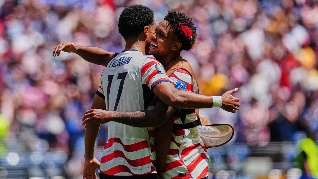 United States' Malik Tillman (17) and United States' Weston McKennie (8) celebrate after winning the World Cup Group D soccer match against Australia in Seattle. - AP Photo