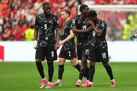 Canada's Jonathan David, right, becomes emotional after Ismael Kone sustained an injury and was taken off the field during the World Cup Group B soccer match against Qatar in Vancouver, British Columbia, Thursday, June 18, 2026.