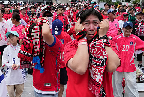 South Korean soccer fans react after Mexico scored the opening goal during the World Cup Group A soccer match between South Korea and Mexico at a public viewing venue in Seoul, South Korea.