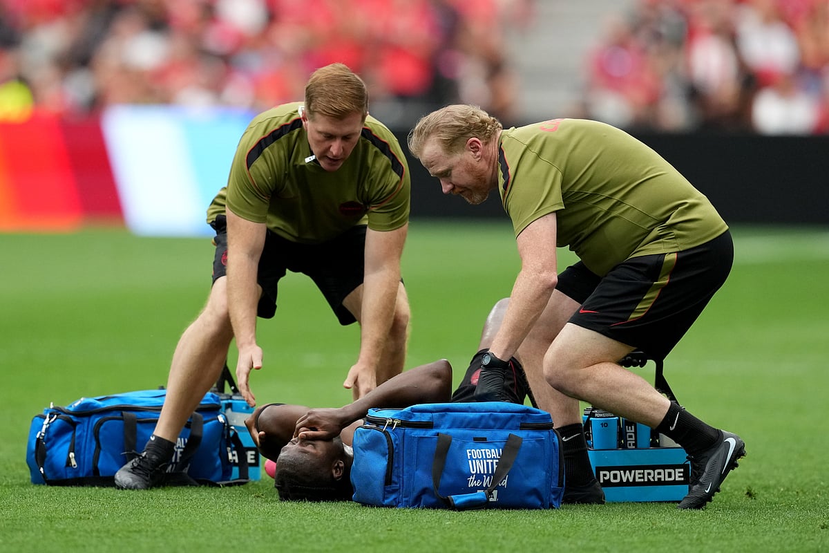 Medical staff attend to Canada's Ismael Kone (8) after he was injured on a play during the World Cup Group B soccer match between Canada and Qatar in Vancouver, British Columbia, Thursday, June 18, 2026. - Ethan Cairns/The Canadian Press via AP
